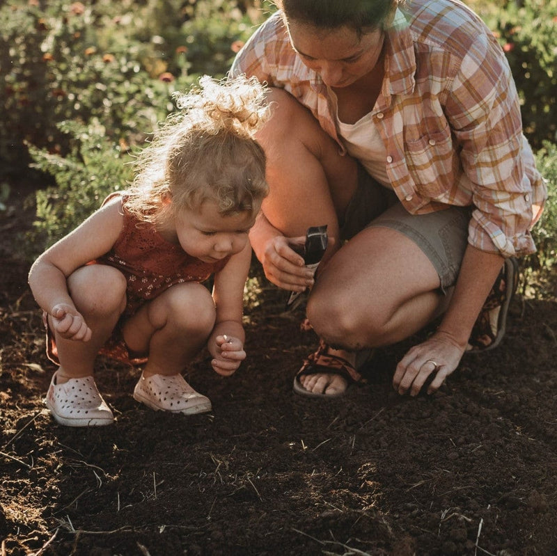 Mom and daughter planting seeds