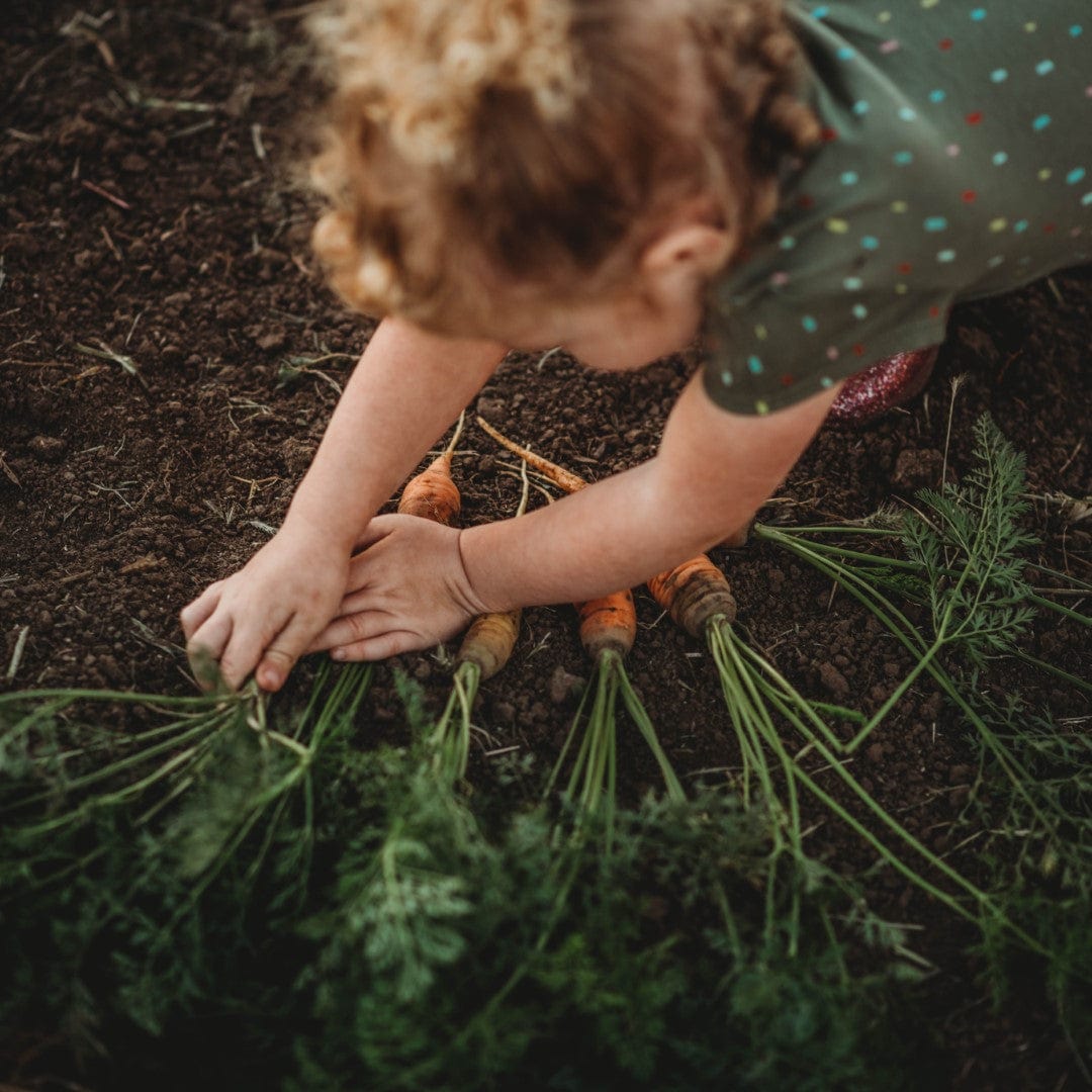 Girl showing off carrots