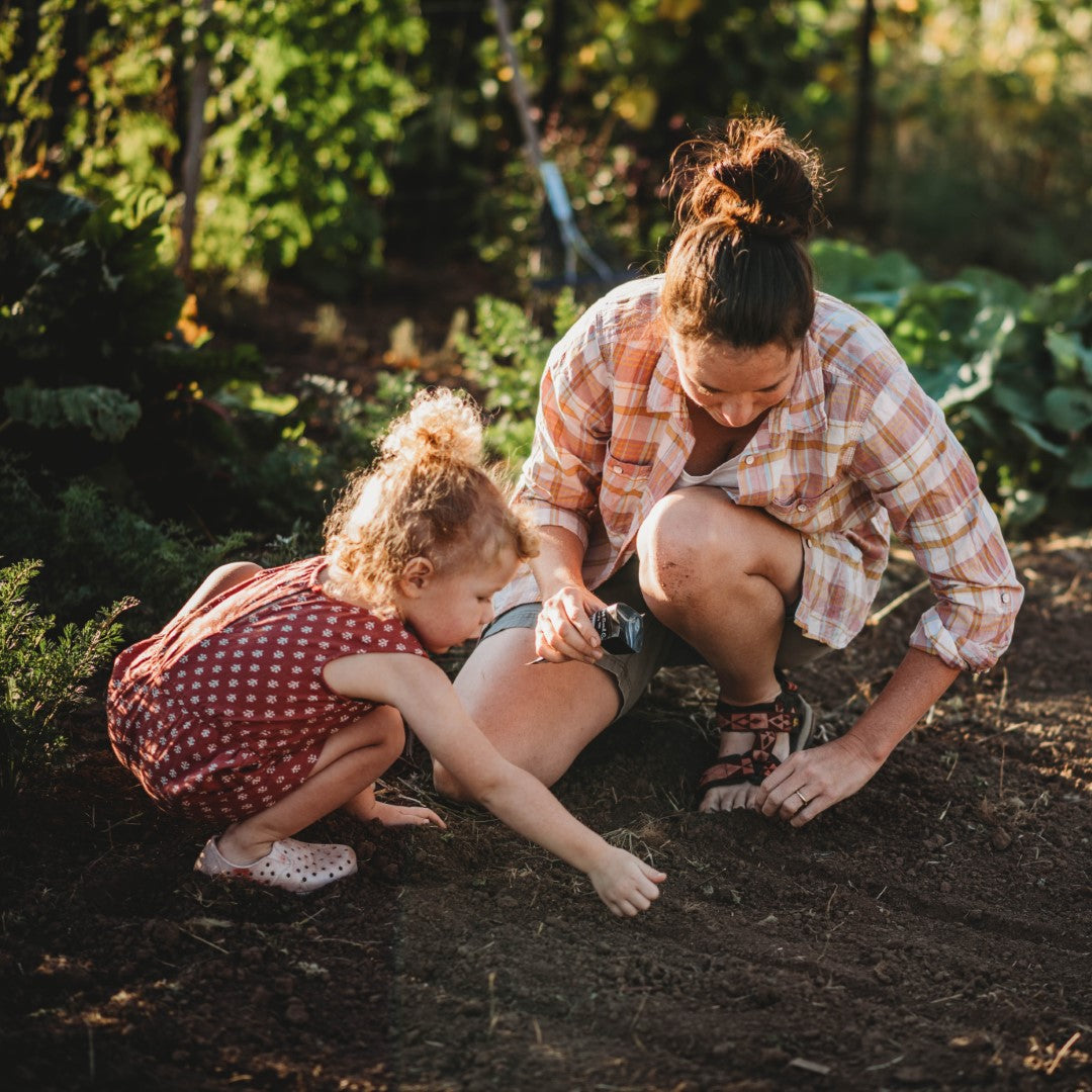 Mom and daughter planting seeds