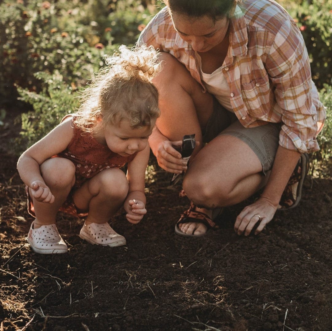 Mom and daughter planting seeds