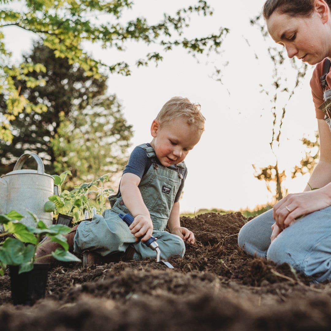 Boy digging a hole in the garden